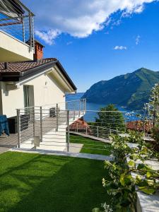 a house with a balcony with a view of the water at Iseo Collection in Riva di Solto