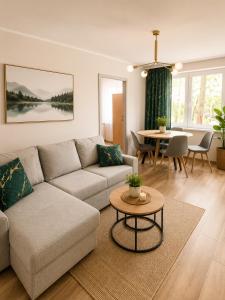 a living room with a couch and a table at Family Spot in Konin