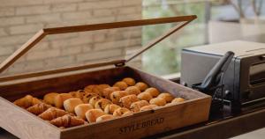 a wooden box filled with different types of doughnuts at Nesthotel Alt Meguro Ekimae in Tokyo +24 photos