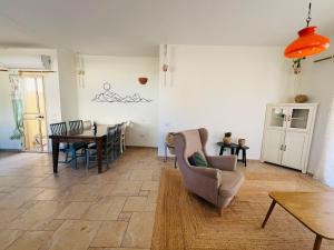 a living room with a table and a chair at לנשום בצוקים in Zuqim +18 photos