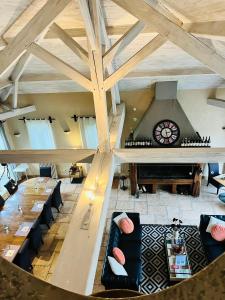 a room with couches and a table and a piano at La Marelle in Corberon