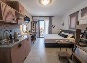 a room with a bed and a kitchen with a sink at Olea Luxury Suites in Asprovalta +62 photos