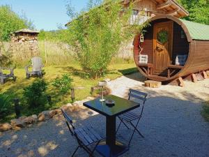 a table and chairs in front of a small cabin at Lagarta , la buche in Étival +13 photos