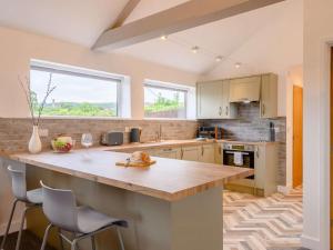 a kitchen with a large kitchen island with chairs at 1 Bed in Wells oc-88969 in Wells