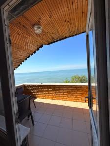 a view of the ocean from the balcony of a house at Divisey Pansiyon in Unye