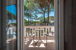 a view of a balcony with a table and chairs at Hotel Caracas in Lignano Sabbiadoro