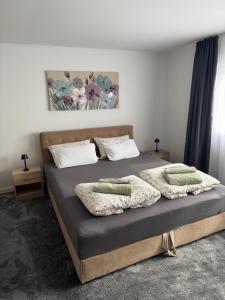 a bedroom with a bed with two pillows on it at House Sweet stay by Deda Ferda late self check in in Draganići