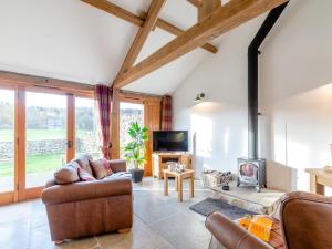 a living room with a couch and a fireplace at 1 Bed in Ripon oc-80303 in Thornton Steward