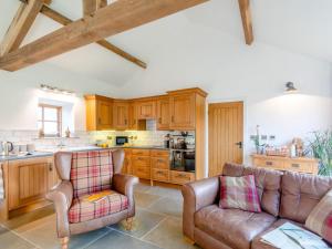 a kitchen with two leather chairs and a couch at 1 Bed in Ripon oc-80303 in Thornton Steward +12 photos