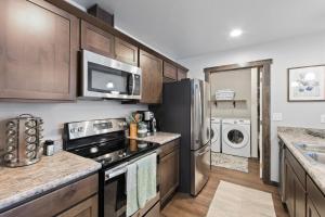 a kitchen with a refrigerator and a microwave at Destiny Cove in Kalispell