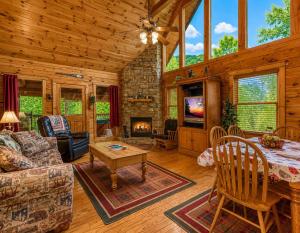 a living room with a table and a fireplace at Cub Crossing, Free Attraction Tickets, Hot Tub, Pool Table, WIFI!!! in Sevierville