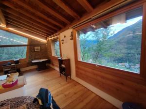 a room with a large window in a house at La Baita nel Bosco in Berzo