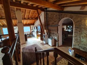 an open living room with an archway in a house at La Baita nel Bosco in Berzo