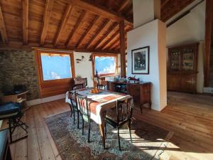 a dining room with a table and chairs at La Baita nel Bosco in Berzo