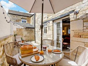 a table with a loaf of bread sitting on a patio at 1 Bed in Stamford oc-92406 in Ketton