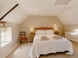 a bedroom with a large bed with two towels on it at 1 Bed in Stamford oc-92406 in Ketton