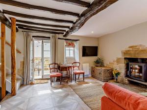 a living room with a table and a fireplace at 1 Bed in Stamford oc-92406 in Ketton