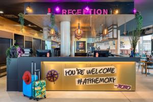 a restaurant with a sign that says youre welcome at the counter at Moxy Hamburg Altona in Hamburg