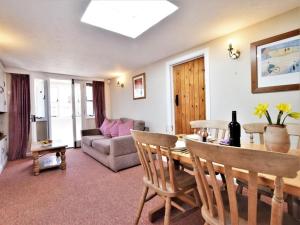 a living room with a table and a couch at 1 Bed in Swanage oc-dc098 in Swanage