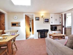 a living room with a couch and a table at 1 Bed in Swanage oc-dc098 in Swanage
