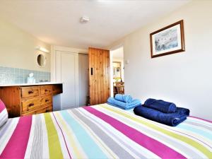 a bedroom with a bed with two blue pillows on it at 1 Bed in Swanage oc-dc098 in Swanage