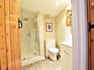 a bathroom with a shower and a toilet at 1 Bed in Swanage oc-dc098 in Swanage +4 photos