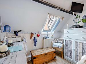 a small attic room with a window and a table at 1 Bed in Lymington oc-94751 in Lymington