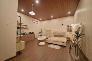a bedroom with a bed and a desk and a kitchen at Àla Homestay Cần Thơ in Can Tho