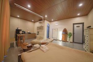 a room with two beds and a living room at Àla Homestay Cần Thơ in Can Tho +16 photos