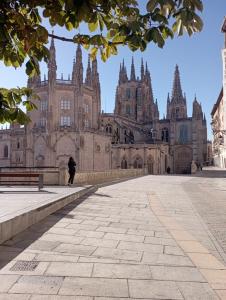 a person walking in front of a large building at Living Burgos in Burgos