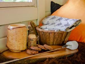 a table with a cutting board and a basket and food at 1 Bed in Aylesbury oc-76403 in Ludgershall