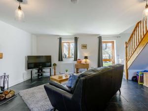 a living room with a couch and a television at 1 Bed in Lydney oc-43724 in Lydney