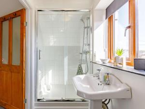 a white bathroom with a sink and a shower at 1 Bed in Lydney oc-43724 in Lydney +13 photos