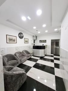 a living room with couches and a checkered floor at Hotel Solferino in Brescia