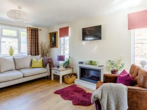 a living room with a couch and a fireplace at 2 Bed in Ashbourne oc-81345 in Clifton