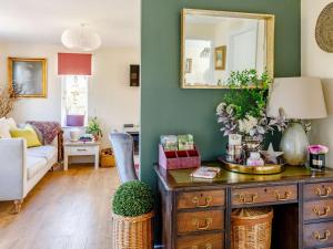a living room with a wooden dresser with a mirror at 2 Bed in Ashbourne oc-81345 in Clifton