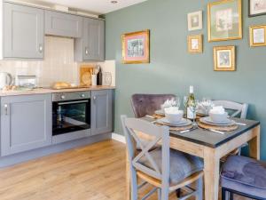 a kitchen with a table and chairs in a kitchen at 2 Bed in Ashbourne oc-81345 in Clifton