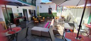a living room with a couch and a table and chairs at Pukari Hotel Cusco in Cusco