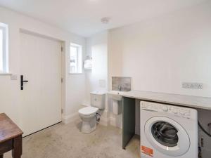 a bathroom with a washing machine and a toilet at 1 Bed in Carnforth oc-90554 in Middleton +13 photos