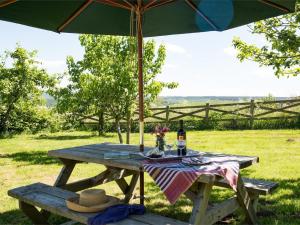 a picnic table with a hat and an umbrella at 1 Bed in Riding Mill oc-cn063 in Corbridge +8 photos