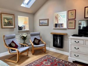 a living room with two chairs and a fireplace at 1 Bed in Riding Mill oc-cn063 in Corbridge