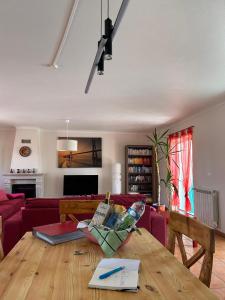 a living room with a table and a couch at Poolvilla Casa Sol in Aljezur