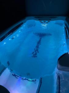 a pool of water with blue lights in it at KVS concept Écommoy chambres haut de gamme proche circuit 24 heures Le Mans in Écommoy