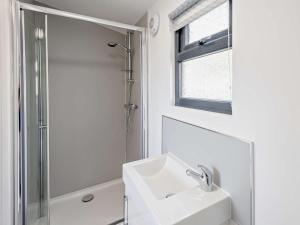 a white bathroom with a sink and a shower at 1 Bed in Weymouth oc-82099 in Osmington