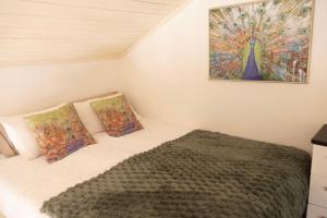 a bedroom with a bed and a painting on the wall at Quinta Cabecinha in Penela +48 photos