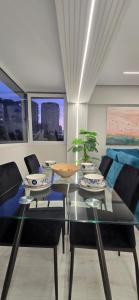 a dining room with a glass table and chairs at Promenade Apartment ,Sea view in Durrës