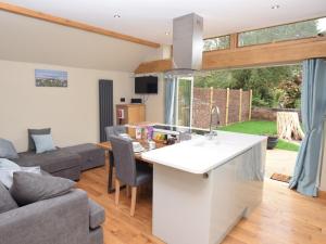 a kitchen and living room with a couch at 1 Bed in Lymington oc-50723 in Sway