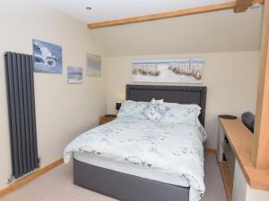 a bedroom with a bed with a white comforter at 1 Bed in Lymington oc-50723 in Sway