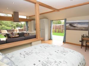 a bedroom with a bed and a living room at 1 Bed in Lymington oc-50723 in Sway