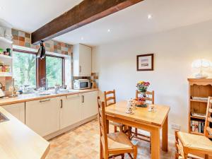 a kitchen with a wooden table and a table and chairs at 2 Bed in Skipton oc-92898 in Airton